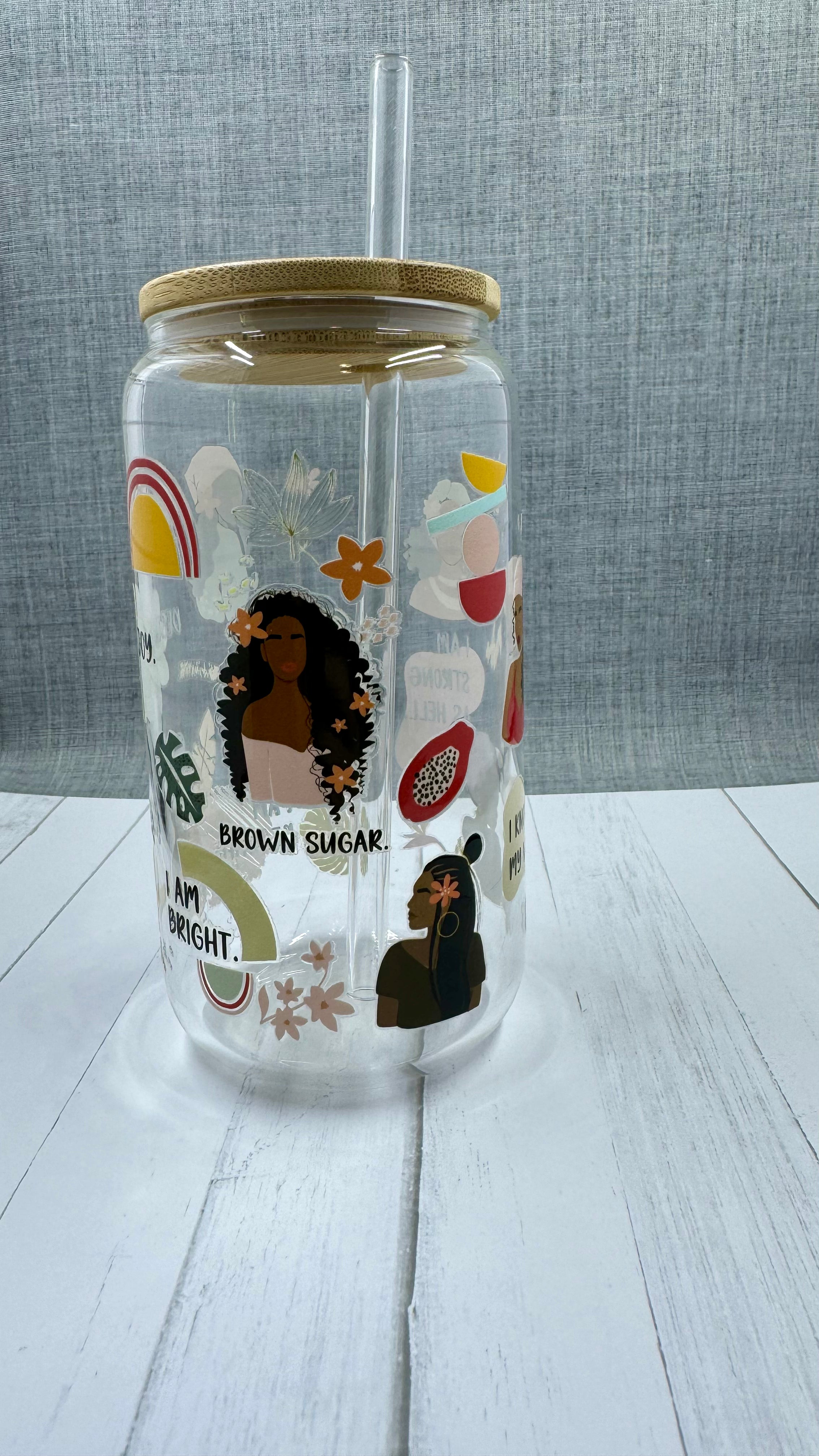 Sip in style with our "I am..." Glass Tumbler. This 16 ounce tumbler features a durable UV DTF transfer, showcasing empowering statements such as "strong as hell" and "beautiful brown sugar." Show off your confidence while staying hydrated.