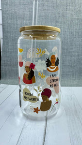 Sip in style with our "I am..." Glass Tumbler. This 16 ounce tumbler features a durable UV DTF transfer, showcasing empowering statements such as "strong as hell" and "beautiful brown sugar." Show off your confidence while staying hydrated.