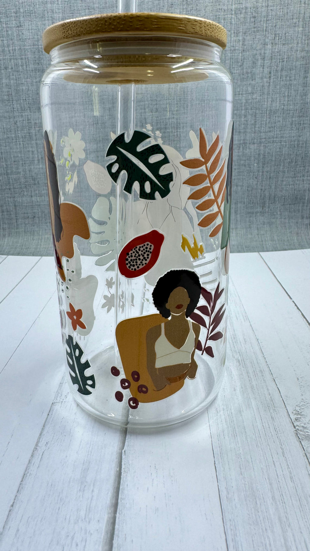 This Black Girl Glass Tumbler along with a glass straw holds 16 ounces and is wrapped in durable UV DTF material, ensuring long-lasting use for all your beverages. Showcasing a black girl design, this tumbler is both stylish and functional, making it the perfect choice for any drink on-the-go.