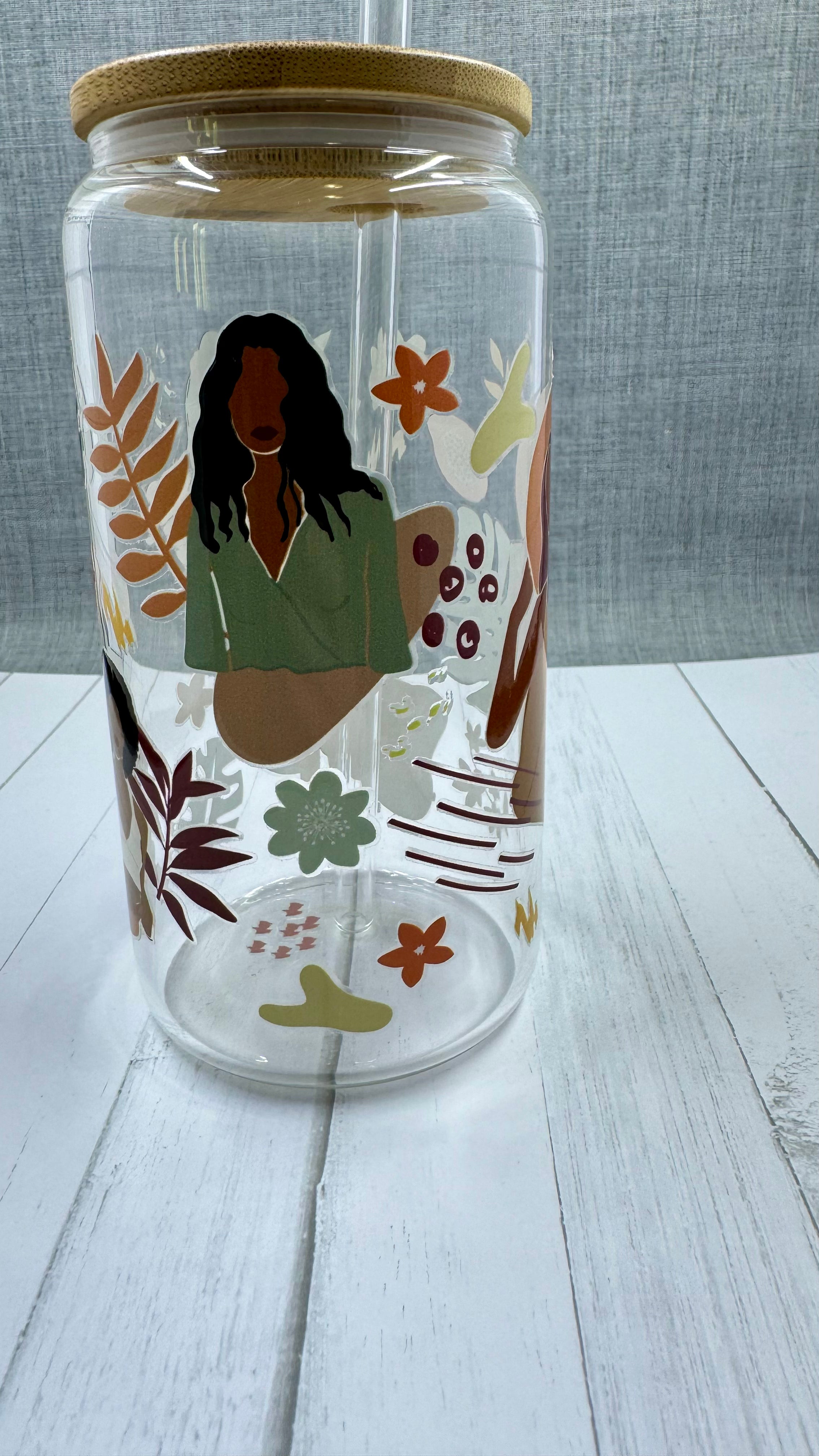 This Black Girl Glass Tumbler along with a glass straw holds 16 ounces and is wrapped in durable UV DTF material, ensuring long-lasting use for all your beverages. Showcasing a black girl design, this tumbler is both stylish and functional, making it the perfect choice for any drink on-the-go.