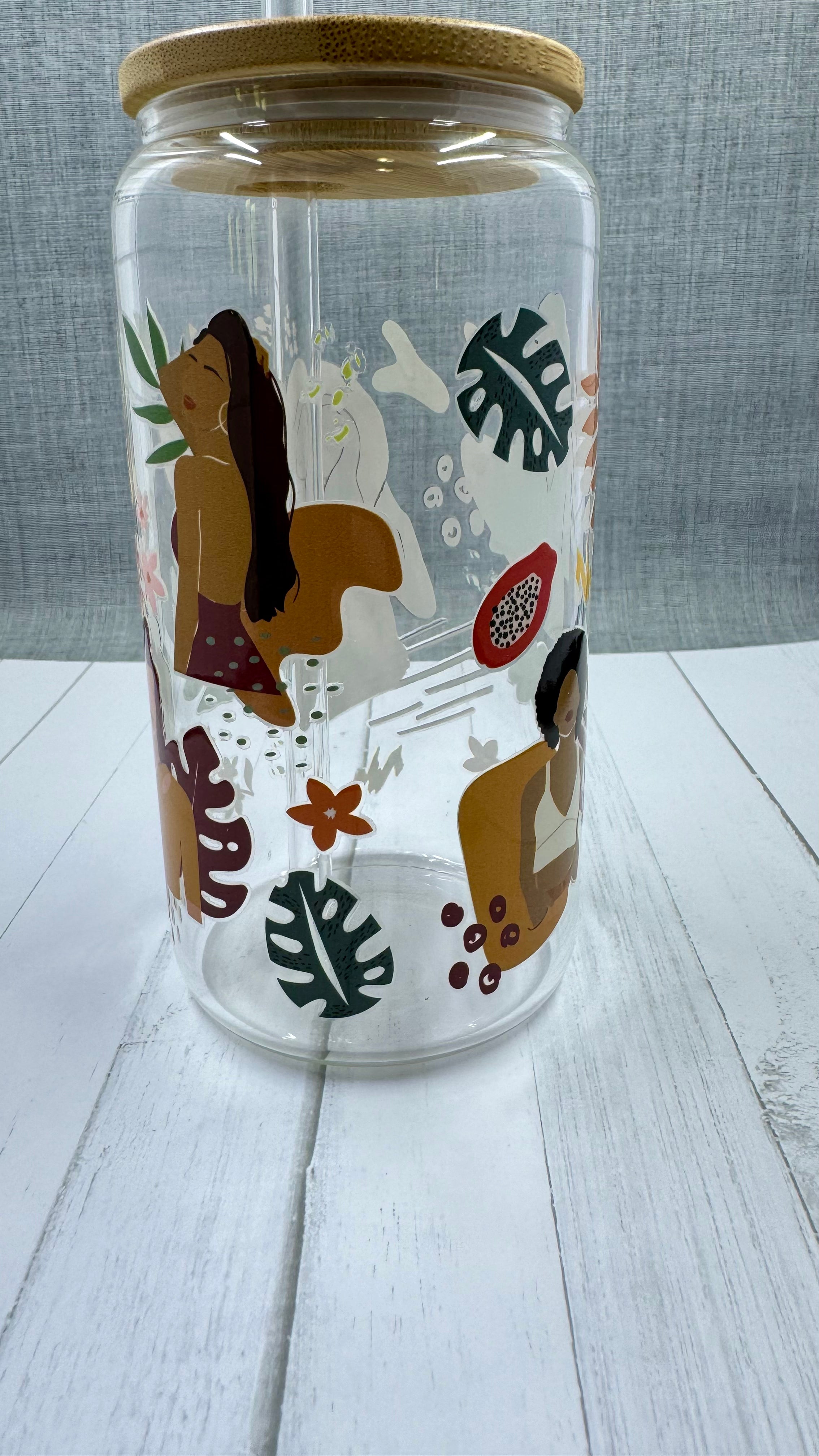 This Black Girl Glass Tumbler along with a glass straw holds 16 ounces and is wrapped in durable UV DTF material, ensuring long-lasting use for all your beverages. Showcasing a black girl design, this tumbler is both stylish and functional, making it the perfect choice for any drink on-the-go.