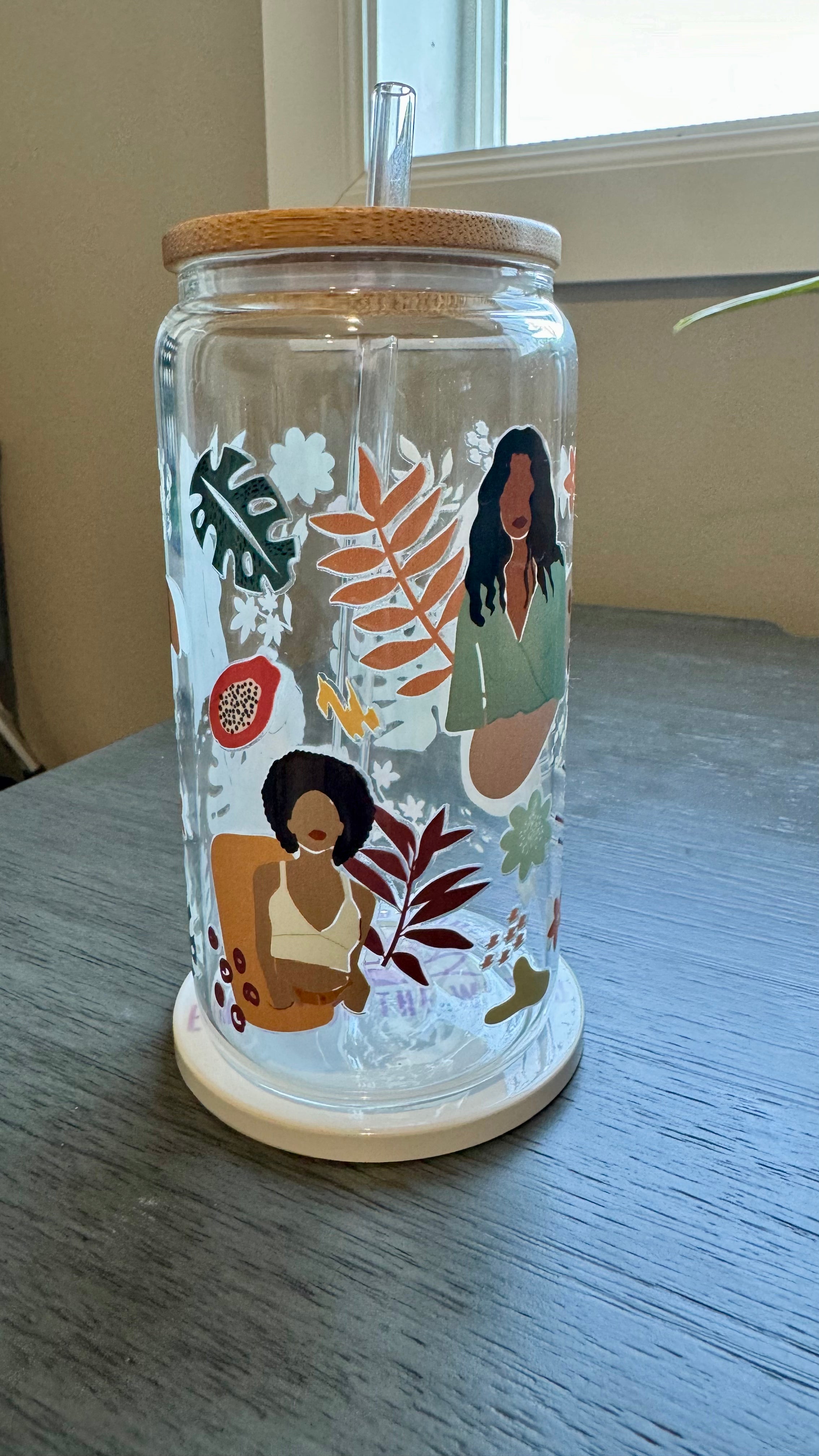 This Black Girl Glass Tumbler along with a glass straw holds 16 ounces and is wrapped in durable UV DTF material, ensuring long-lasting use for all your beverages. Showcasing a black girl design, this tumbler is both stylish and functional, making it the perfect choice for any drink on-the-go.