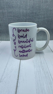 Our Affirmation Mug is a beautiful and durable ceramic mug that features an affirmation reminder that you are brave, bold, beautiful, resilient, authentic, and loved. The infusible ink used in the design process ensures long-lasting and vibrant colors, making this mug a perfect addition to any collection. Create a unique and stylish statement with this expertly crafted mug.