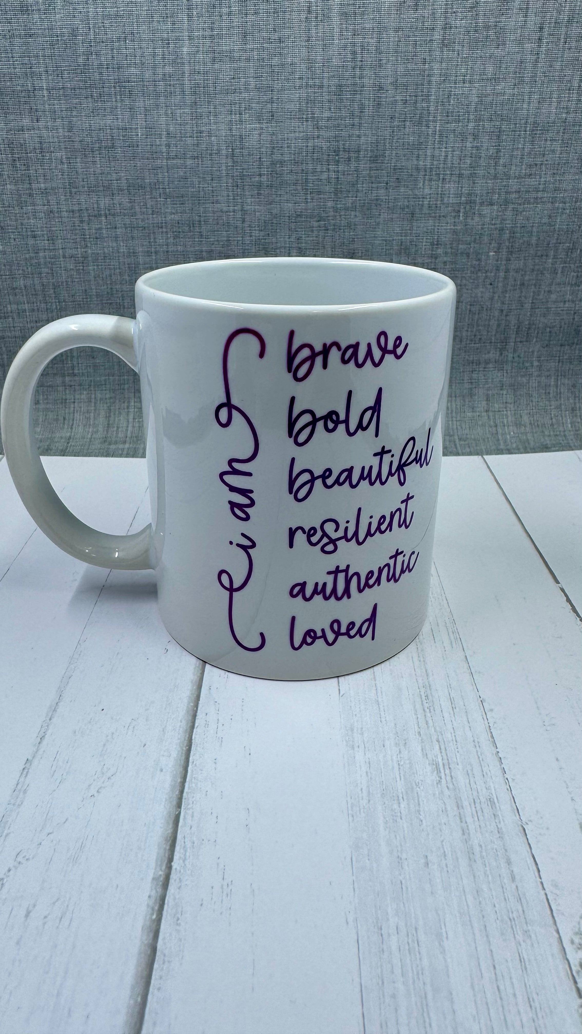 Our Affirmation Mug is a beautiful and durable ceramic mug that features an affirmation reminder that you are brave, bold, beautiful, resilient, authentic, and loved. The infusible ink used in the design process ensures long-lasting and vibrant colors, making this mug a perfect addition to any collection. Create a unique and stylish statement with this expertly crafted mug.