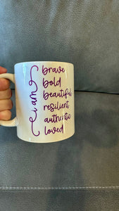 Our Affirmation Mug is a beautiful and durable ceramic mug that features an affirmation reminder that you are brave, bold, beautiful, resilient, authentic, and loved. The infusible ink used in the design process ensures long-lasting and vibrant colors, making this mug a perfect addition to any collection. Create a unique and stylish statement with this expertly crafted mug.