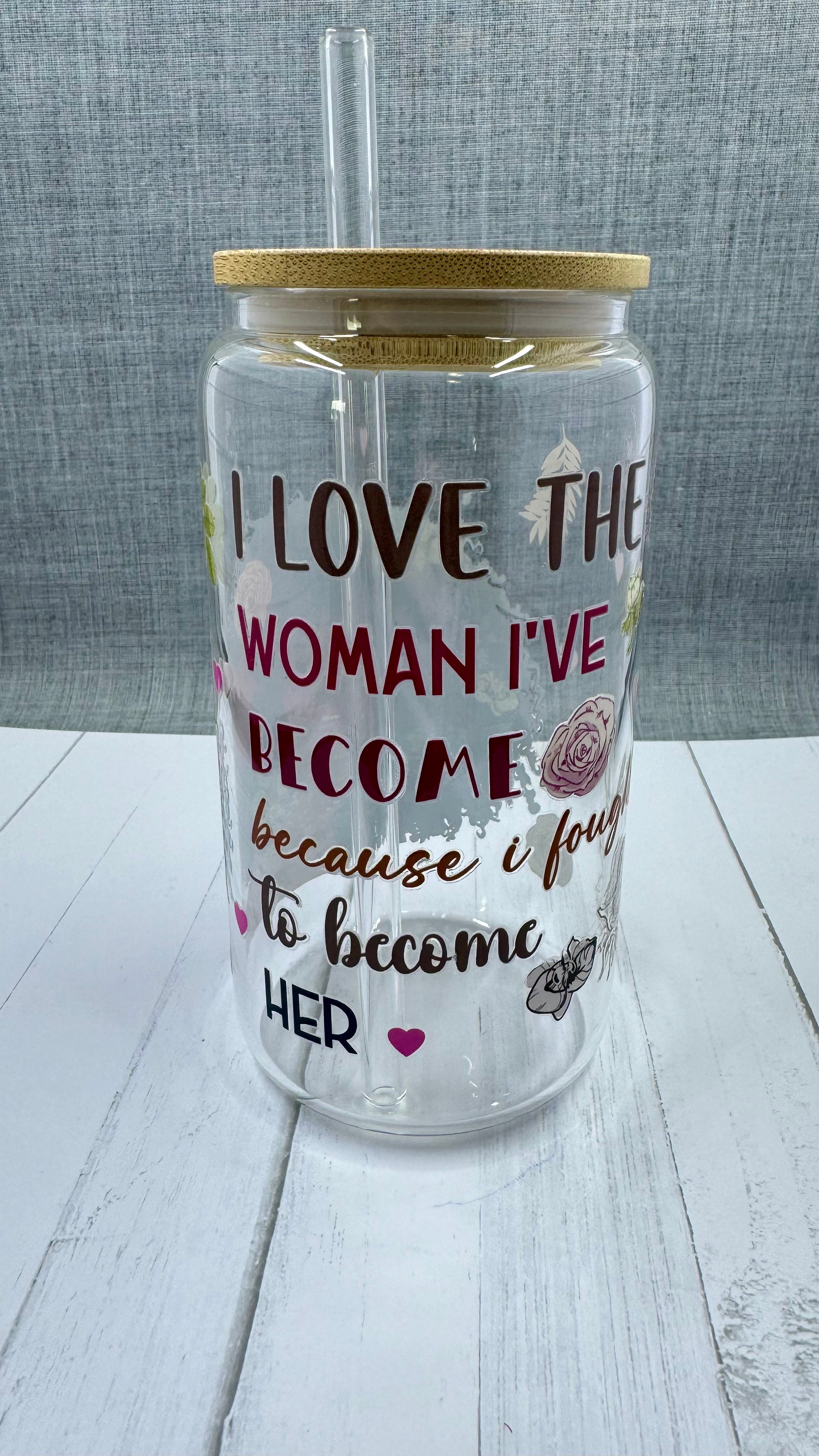 Elevate your drinkware with our 16 ounce glass tumbler featuring UV DTF transfer of our empowering phrase, "I love the woman I've become because I fought to become her". As a black queen, show your strength with every sip.