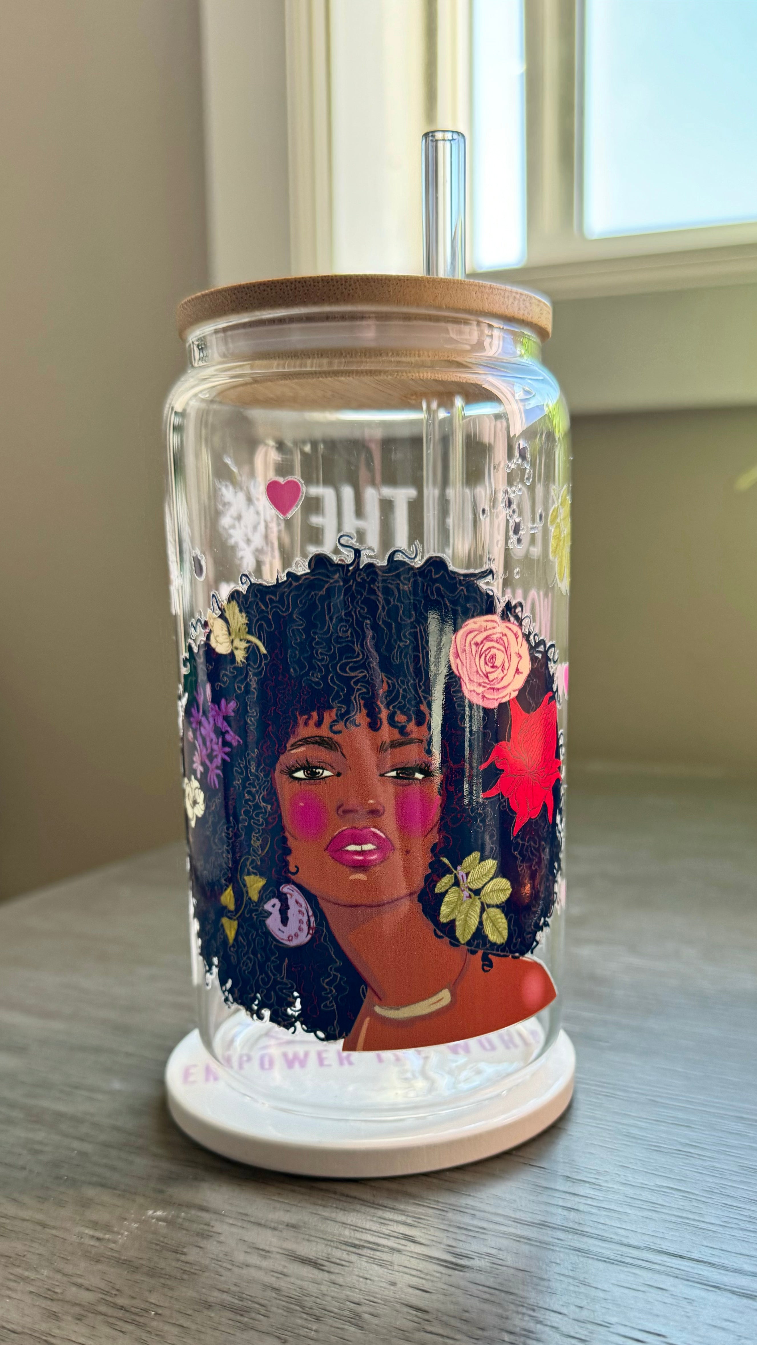 Elevate your drinkware with our 16 ounce glass tumbler featuring UV DTF transfer of our empowering phrase, "I love the woman I've become because I fought to become her". As a black queen, show your strength with every sip.