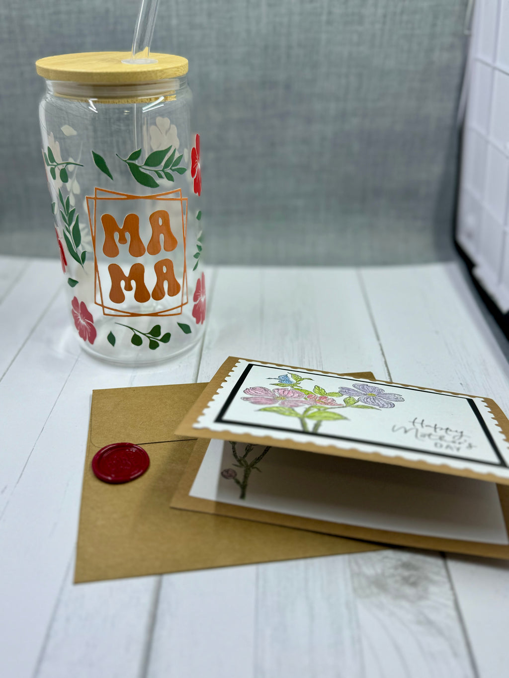 Celebrate Mother's Day with our MAMA Glass Tumbler Set. This 16oz tumbler features a unique UV DTF transfer, perfect for moms who appreciate quality and style. The set also includes a beautifully designed Mother's Day card with a wax seal for an extra personal touch. Show your love and appreciation with this thoughtful gift set.