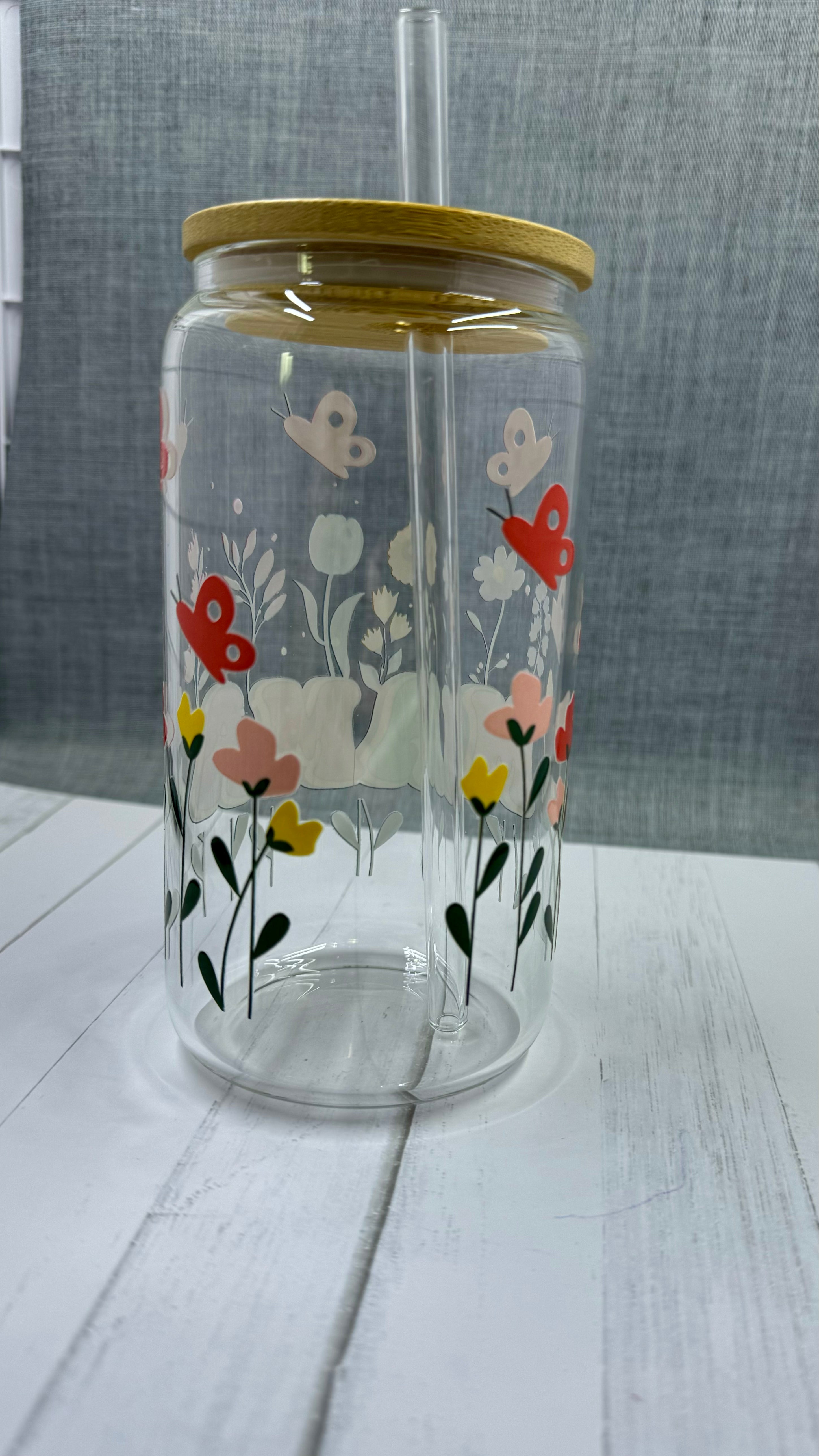 The MAMA Glass Tumbler features a beautiful UV DTF transfer design of flowers and butterflies. With a 16 ounce capacity, it is perfect for your favorite cold beverages. Stay hydrated and in style with this elegant and durable tumbler.