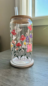 The MAMA Glass Tumbler features a beautiful UV DTF transfer design of flowers and butterflies. With a 16 ounce capacity, it is perfect for your favorite cold beverages. Stay hydrated and in style with this elegant and durable tumbler.