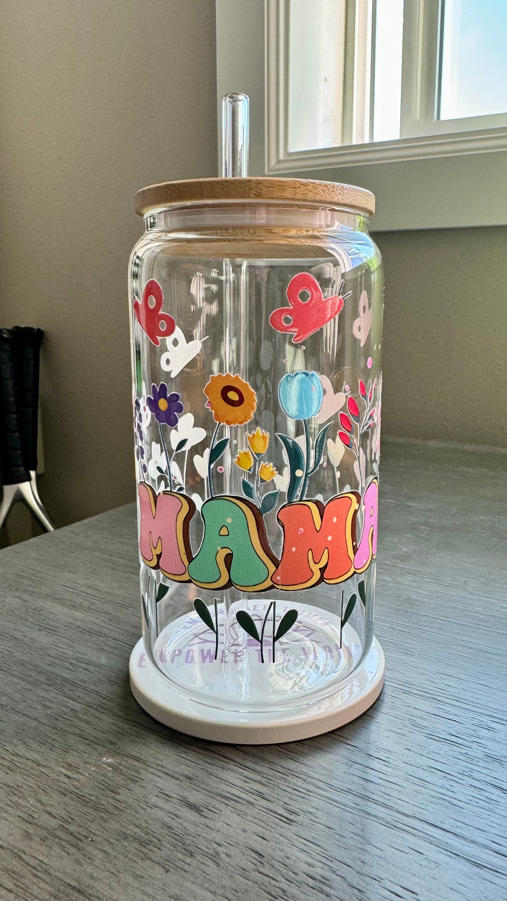 The MAMA Glass Tumbler features a beautiful UV DTF transfer design of flowers and butterflies. With a 16 ounce capacity, it is perfect for your favorite cold beverages. Stay hydrated and in style with this elegant and durable tumbler.