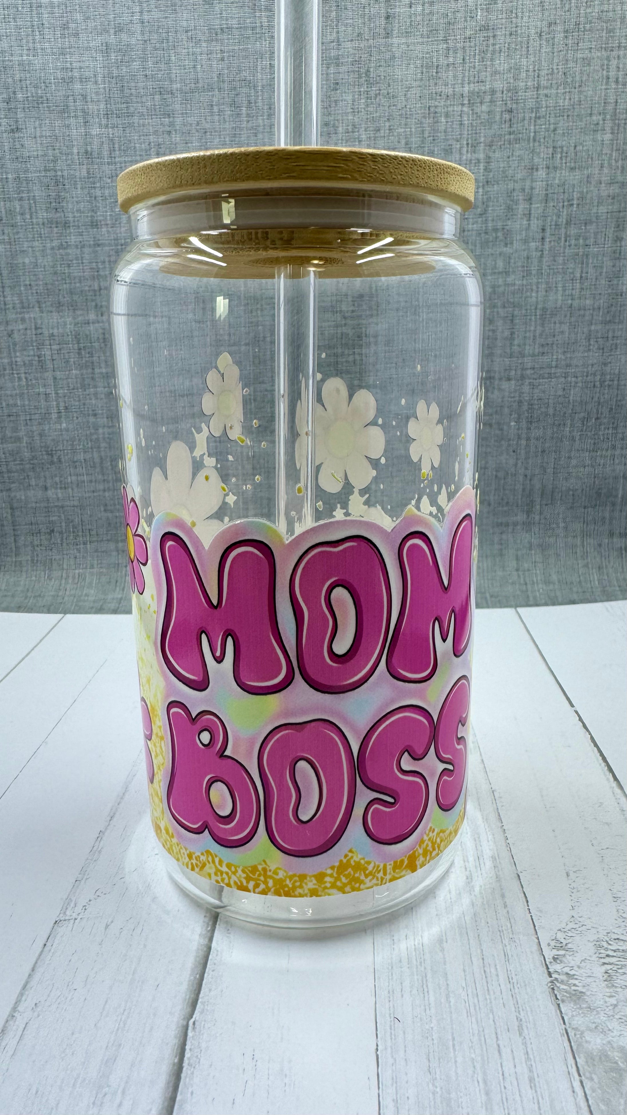 This 16 ounce Mom Boss Glass Tumbler is the perfect accessory for every working mom. The UV DTF transfer ensures long-lasting quality, while the vibrant pink and yellow floral design adds a touch of femininity. Stay hydrated and motivated with this empowering tumbler.