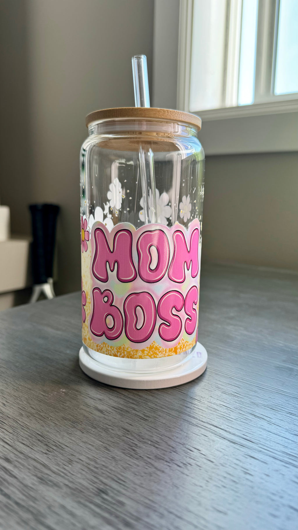 This 16 ounce Mom Boss Glass Tumbler is the perfect accessory for every working mom. The UV DTF transfer ensures long-lasting quality, while the vibrant pink and yellow floral design adds a touch of femininity. Stay hydrated and motivated with this empowering tumbler.