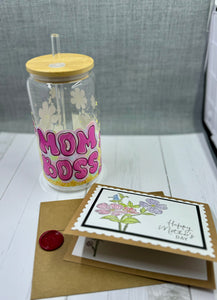 Celebrate Mother's Day with our Mom Boss Glass Tumbler Set. This 16oz tumbler features a unique UV DTF transfer, perfect for moms who appreciate quality and style. The set also includes a beautifully designed Mother's Day card with a wax seal for an extra personal touch. Show your love and appreciation with this thoughtful gift set.