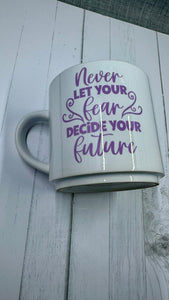 This mug is a beautiful and durable ceramic mug that features an important reminder to never let your fear decide your future. The infusible ink used in the design process ensures long-lasting and vibrant colors, making this mug a perfect addition to any collection. Create a unique and stylish statement with this expertly crafted mug.