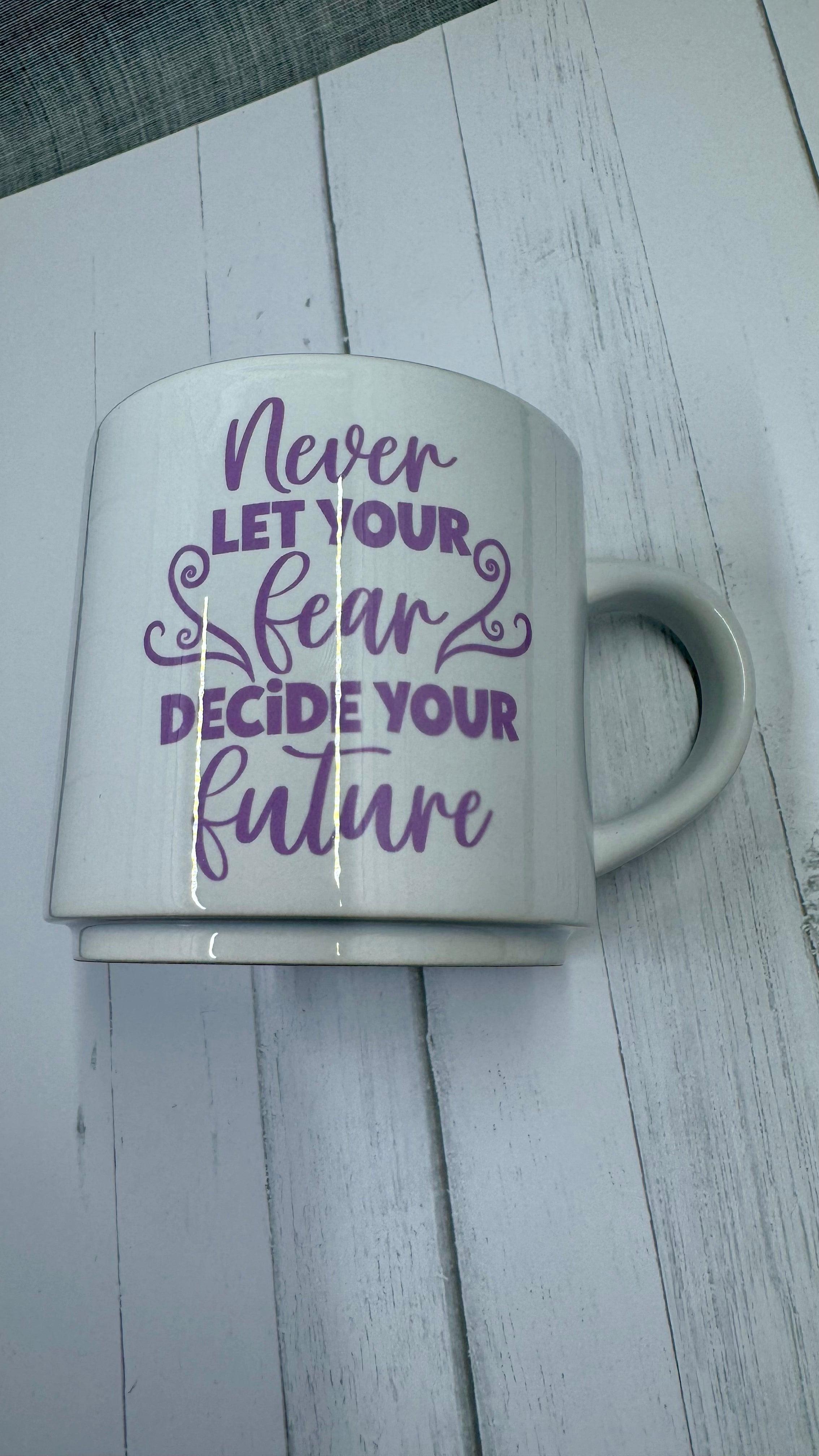 This mug is a beautiful and durable ceramic mug that features an important reminder to never let your fear decide your future. The infusible ink used in the design process ensures long-lasting and vibrant colors, making this mug a perfect addition to any collection. Create a unique and stylish statement with this expertly crafted mug.