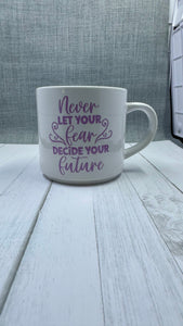 This mug is a beautiful and durable ceramic mug that features an important reminder to never let your fear decide your future. The infusible ink used in the design process ensures long-lasting and vibrant colors, making this mug a perfect addition to any collection. Create a unique and stylish statement with this expertly crafted mug.