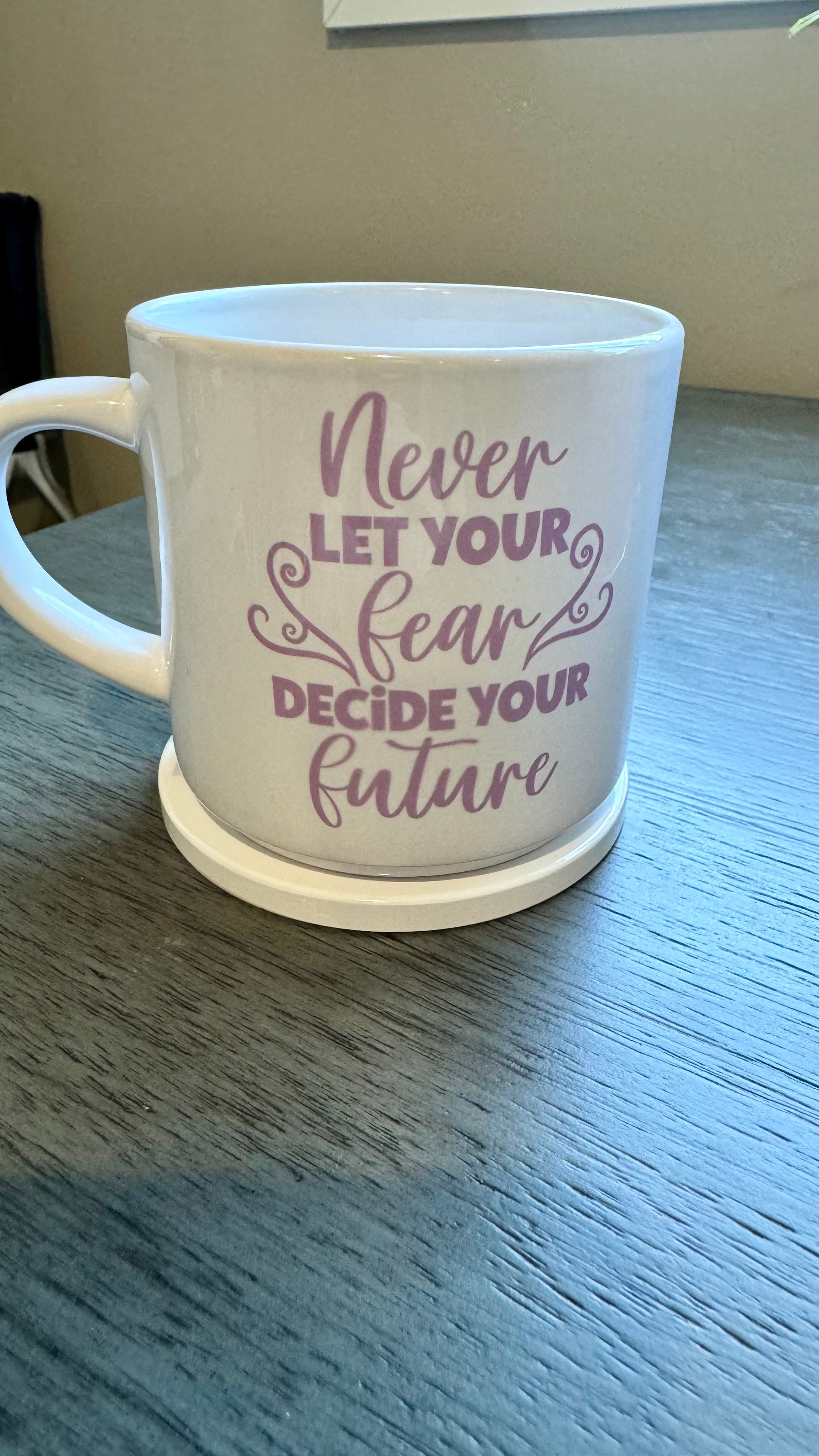 This mug is a beautiful and durable ceramic mug that features an important reminder to never let your fear decide your future. The infusible ink used in the design process ensures long-lasting and vibrant colors, making this mug a perfect addition to any collection. Create a unique and stylish statement with this expertly crafted mug.