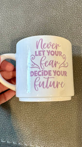 This mug is a beautiful and durable ceramic mug that features an important reminder to never let your fear decide your future. The infusible ink used in the design process ensures long-lasting and vibrant colors, making this mug a perfect addition to any collection. Create a unique and stylish statement with this expertly crafted mug.