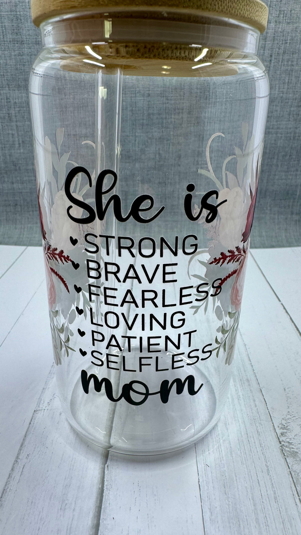 Elevate your gift-giving game with our She is...mom Glass Tumbler. Crafted with a 16 ounce capacity, this tumbler is adorned with beautiful red and pink roses. The UV DTF transfer showcases the phrase "she is strong brave fearless loving patient selfless mom", making it the perfect way to show appreciation for the special mom in your life.