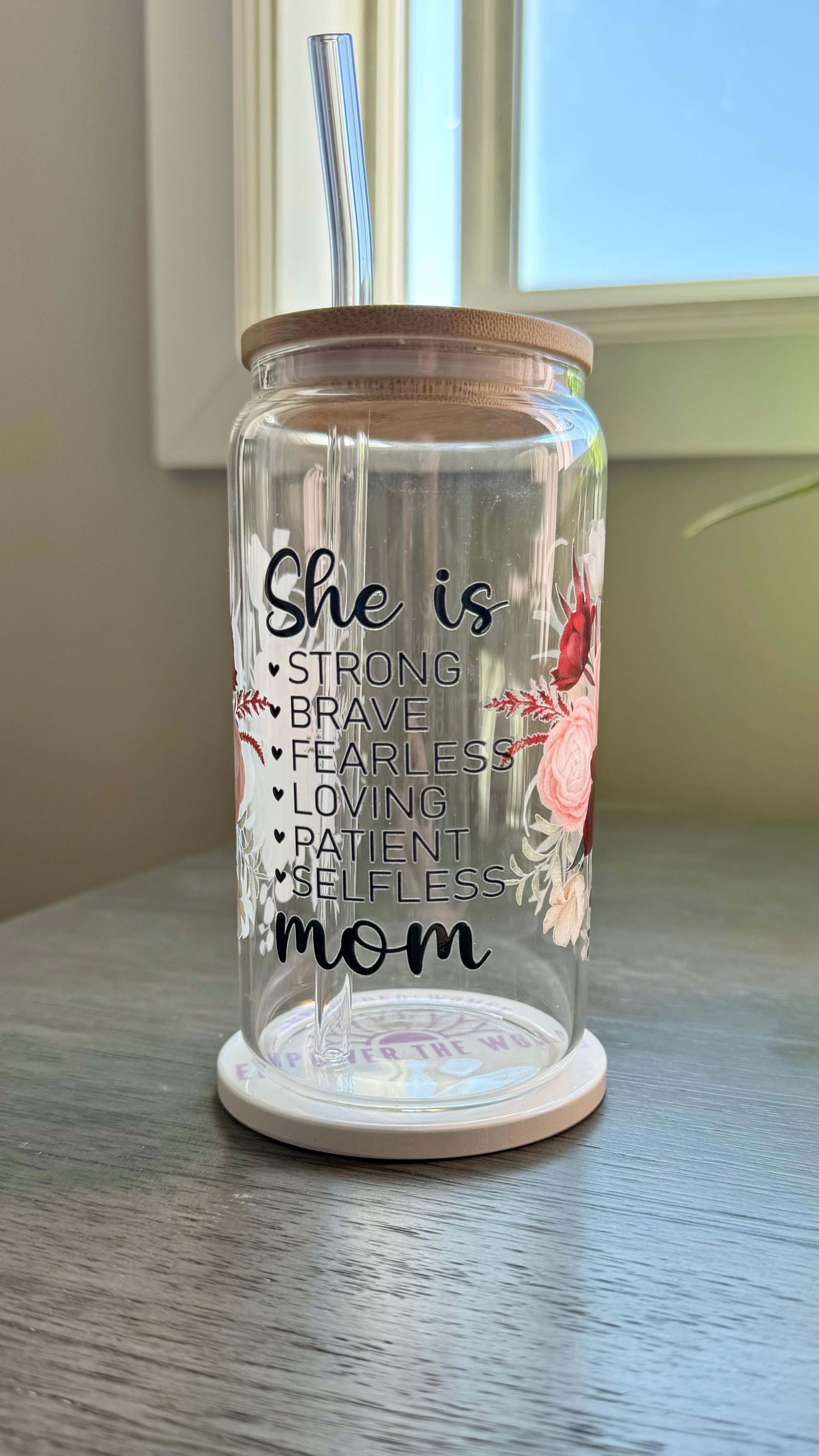 Elevate your gift-giving game with our She is...mom Glass Tumbler. Crafted with a 16 ounce capacity, this tumbler is adorned with beautiful red and pink roses. The UV DTF transfer showcases the phrase "she is strong brave fearless loving patient selfless mom", making it the perfect way to show appreciation for the special mom in your life.