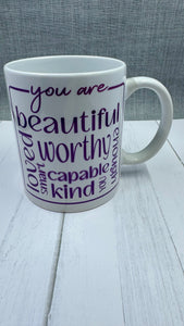 Our Affirmation Mug is a beautiful and durable ceramic mug that features an affirmation reminder that you are beautiful, loved, smart, capable, kind, worthy, and enough. The infusible ink used in the design process ensures long-lasting and vibrant colors, making this mug a perfect addition to any collection. Create a unique and stylish statement with this expertly crafted mug.