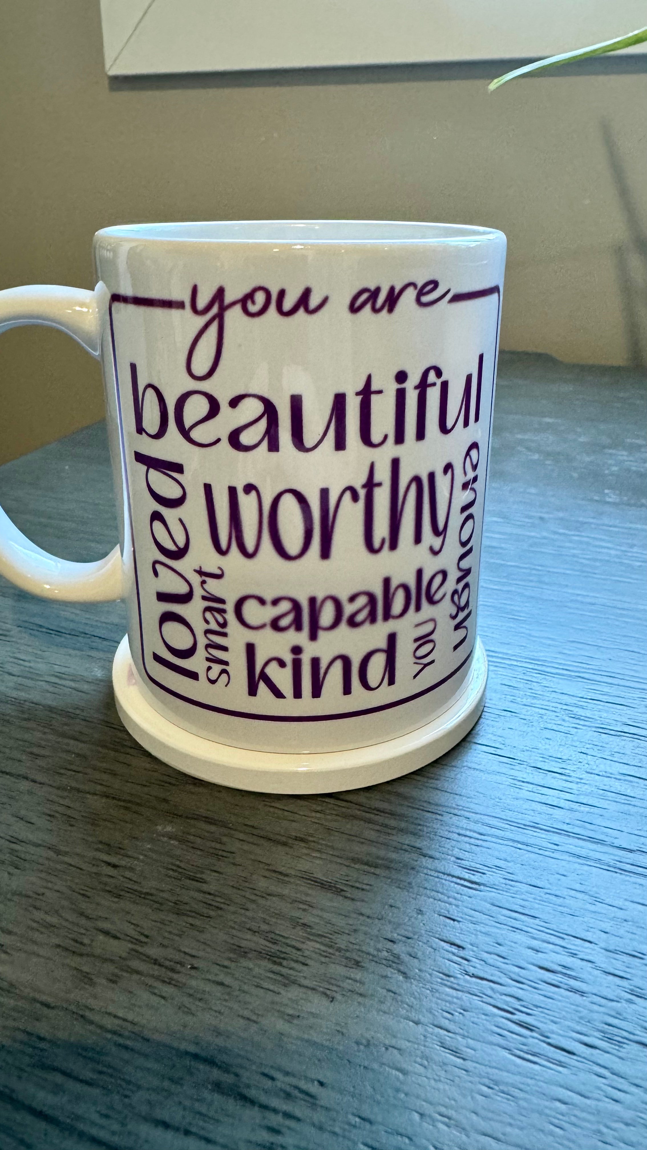 Our Affirmation Mug is a beautiful and durable ceramic mug that features an affirmation reminder that you are beautiful, loved, smart, capable, kind, worthy, and enough. The infusible ink used in the design process ensures long-lasting and vibrant colors, making this mug a perfect addition to any collection. Create a unique and stylish statement with this expertly crafted mug.