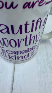 Our Affirmation Mug is a beautiful and durable ceramic mug that features an affirmation reminder that you are beautiful, loved, smart, capable, kind, worthy, and enough. The infusible ink used in the design process ensures long-lasting and vibrant colors, making this mug a perfect addition to any collection. Create a unique and stylish statement with this expertly crafted mug.